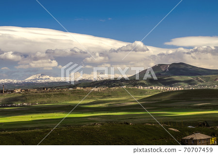 The wind blowing from the Geghama ridge formed a thundercloud in the blue sky with Cumulus clouds moving towards the villages and valleys of Armenia. The wind blowing from the Geghama ridge formed a thundercloud in the blue sky with Cumulus clouds moving towards the villages and valleys of Armenia. 70707459