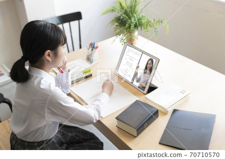 High school girl taking remote lessons at home High school girl taking remote lessons at home 70710570