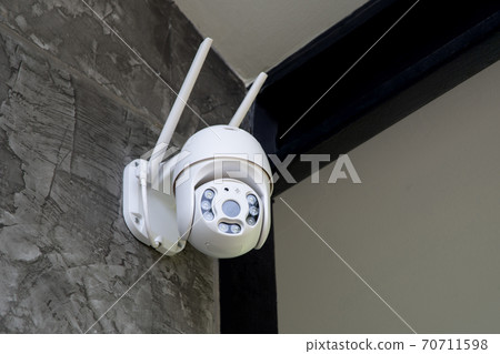Round shape security camera hanging on wall. Round shape security camera hanging on wall. 70711598