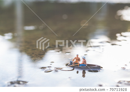 Miniature fishermen are fishing by boat Miniature fishermen are fishing by boat 70711928