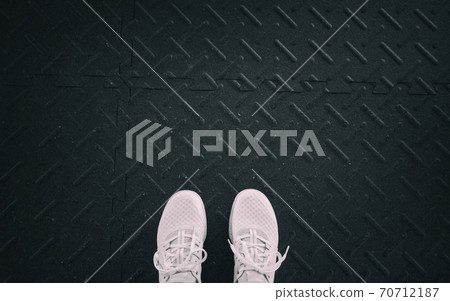 Gym fitness first person top view running shoes selfie at gym. Woman strength training on exercise mat black background with copy space. Active weight loss lifestyle 70712187
