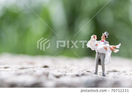 Miniature people : Bride and groom couple standing outdoor , Happy valentine's day concept Miniature people : Bride and groom couple standing outdoor , Happy valentine's day concept 70712231