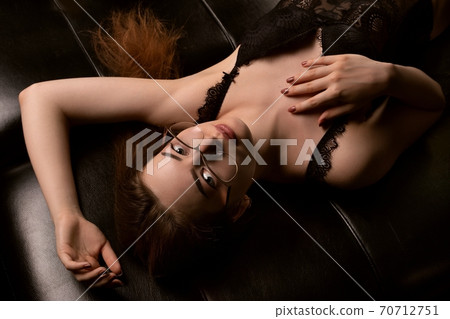 Sensual young woman in lingerie and eyeglasses 70712751