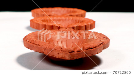 Close up of a beautifully designer handmade clay lamp isolated on white background Close up of a beautifully designer handmade clay lamp isolated on white background 70712860