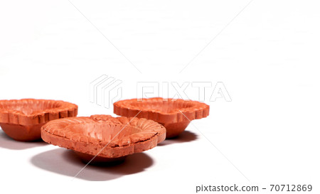 Close up of a beautifully designer handmade clay lamp isolated on white background Close up of a beautifully designer handmade clay lamp isolated on white background 70712869