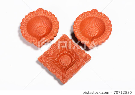 Close up of a beautifully designer handmade clay lamp isolated on white background Close up of a beautifully designer handmade clay lamp isolated on white background 70712880