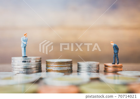 Miniature people businessman standing on money 70714021