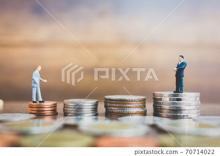 Miniature people businessman standing on money 70714022