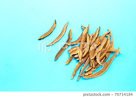 Dried lingzhi mushroom slices on blue background. Dried lingzhi mushroom slices on blue background. 70714184