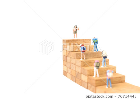 Miniature people: Backpacker standing on wood block isolated on white background, Travel concept 70714443