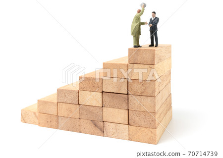 Miniature people: Businessman standing on wood block isolated on white background Miniature people: Businessman standing on wood block isolated on white background 70714739