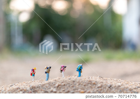 Miniature people : Traveler with backpack walking  on sand , Travel and Adventure concepts. 70714776