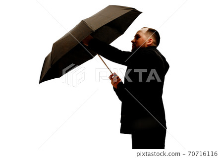 Man with umbrella in studio 70716116