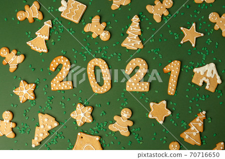 Winter Holiday banner- set of gingerbread on natural green background - Number Happy New Year 2021, house, man in mask, xmas tree sprinkles, Merry Christmas background, trendy concept, flyer 70716650