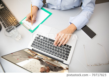 Remote working from home. Workplace in home office with PC, devices and gadgets. Remote working from home. Workplace in home office with PC, devices and gadgets. 70717823