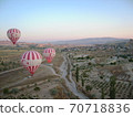 A balloon flying into the sky of Cappadocia at dawn 70718836