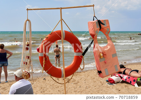 Life-saving appliances on the beach against the background of the sea and sky Life-saving appliances on the beach against the background of the sea and sky 70718859