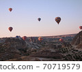 A colorful balloon floating in the sky of Cappadocia in the early morning 70719579