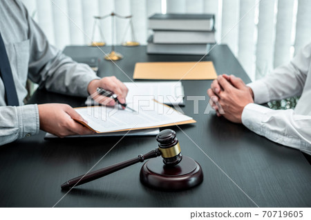 Male lawyer discussing negotiation legal case with client meeting with document contact in courtroom, law and justice concept 70719605