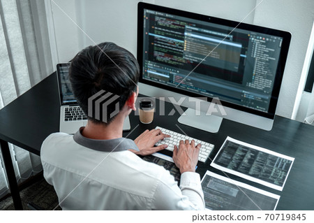 Developer programmer working on coding program software computer in office, Writing website and development database technology 70719845