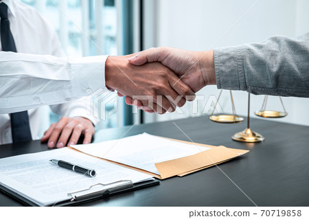 Male lawyer shaking hands with client after good deal negotiation cooperation meeting in courtroom 70719858