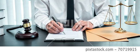 Male lawyer working with legal case document contract in office, law and justice, attorney, lawsuit concept Male lawyer working with legal case document contract in office, law and justice, attorney, lawsuit concept 70719915