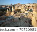 Cappadocia's strange stone dwellings and balloons in the early morning 70720981