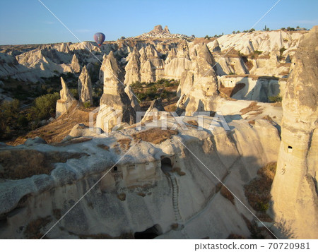 Cappadocia's strange stone dwellings and balloons in the early morning 70720981