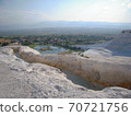 Pamukkale on white lime shelves and distant view of the city 70721756