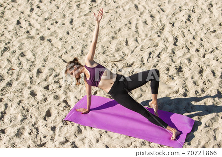 Young woman training outdoors in autumn sunshine. Concept of sport, healthy lifestyle, movement, activity. Young woman training outdoors in autumn sunshine. Concept of sport, healthy lifestyle, movement, activity. 70721866
