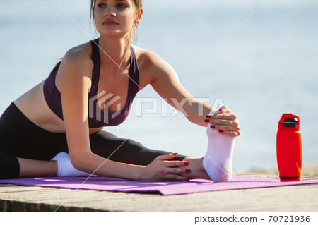 Fitness and lifestyle concept - woman doing sports outdoors Stock