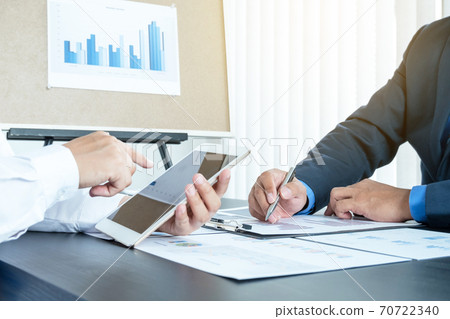 Two business leaders talk about charts, financial graphs showing results are analyzing and calculating planning strategies, business success building processes 70722340