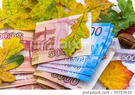 Russian money and autumn leaves, paper money and oak leaves, five thousand and two thousand rubles 70723630