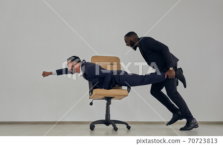 The businessmen playing with chair The businessmen playing with chair 70723813