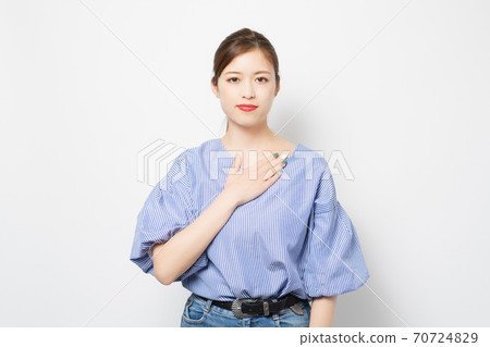 Young woman putting hands on chest Young woman putting hands on chest 70724829