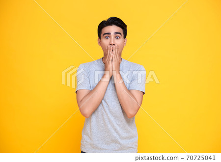 Shocked asian man covering mouth with hands Shocked asian man covering mouth with hands 70725041