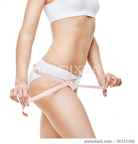 Slim tanned woman's body isolated on white background - waist measurement 70725700