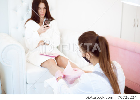 Woman feet receiving pedicure in a Day Spa Woman feet receiving pedicure in a Day Spa 70726224