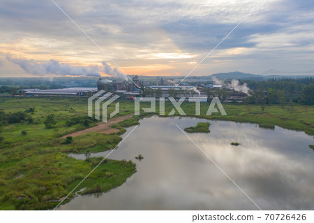 Aerial view of Mae Moh Coal Power Plant with smoke and toxic air from chimney. Factory industry. Electricity tower in energy or pollution environment concept. Lampang City, Thailand 70726426