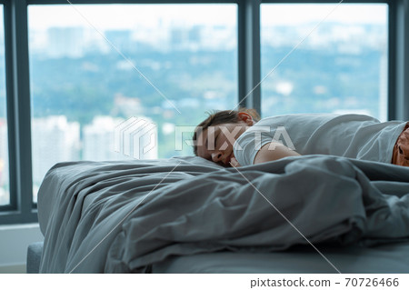 The girl accidentally fell asleep in bed at noon. The girl sleeps in the afternoon in clothes. Short restorative daytime sleep The girl accidentally fell asleep in bed at noon. The girl sleeps in the afternoon in clothes. Short restorative daytime sleep 70726466