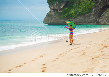 Sexy slim girl with surf board on tropical sand beach. Healthy active lifestyle in summer vocation. Sexy slim girl with surf board on tropical sand beach. Healthy active lifestyle in summer vocation. 70726467