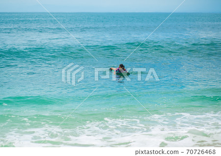 Sexy slim girl riding on surf board in the ocean. Healthy active lifestyle in summer vocation. Sexy slim girl riding on surf board in the ocean. Healthy active lifestyle in summer vocation. 70726468