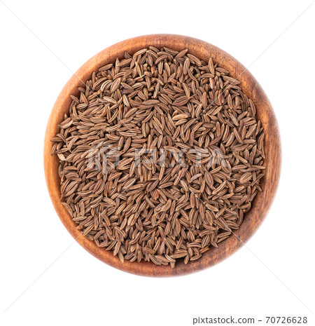 Cumin seeds in wooden bowl, isolated on white background. Cumin seeds or caraway. Top view. Cumin seeds in wooden bowl, isolated on white background. Cumin seeds or caraway. Top view. 70726628
