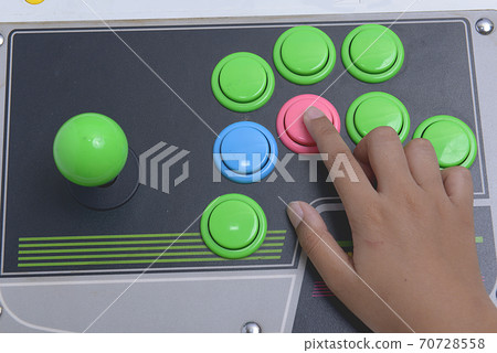 Hand playing the old joystick controller Hand playing the old joystick controller 70728558