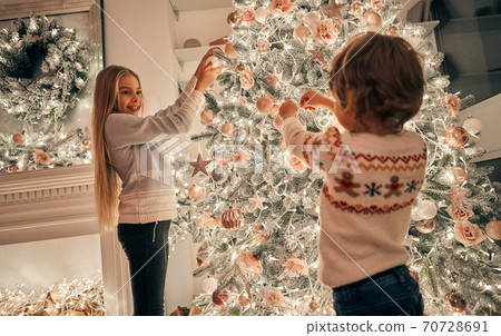 The little girl and boy decorating the christmas tree 70728691