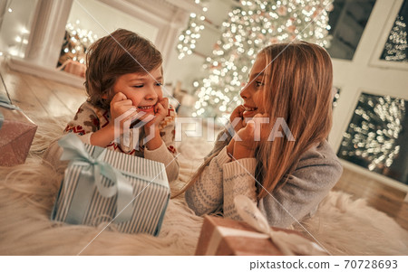 The happy girl and boy with gifts laying on the floor The happy girl and boy with gifts laying on the floor 70728693
