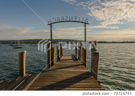 Jetty in Allensbach on Lake Constance with view of Reichenau Island, Baden-Wuerttemberg, Germany Jetty in Allensbach on Lake Constance with view of Reichenau Island, Baden-Wuerttemberg, Germany 70728741