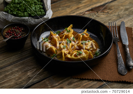 Italian ravioli stuffed with meat closeup on a black plate. rustic style 70729014