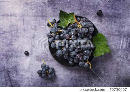 black grape with green leaves black grape with green leaves 70730407