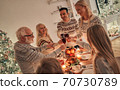The happy family clinking glasses above the christmas table 70730789